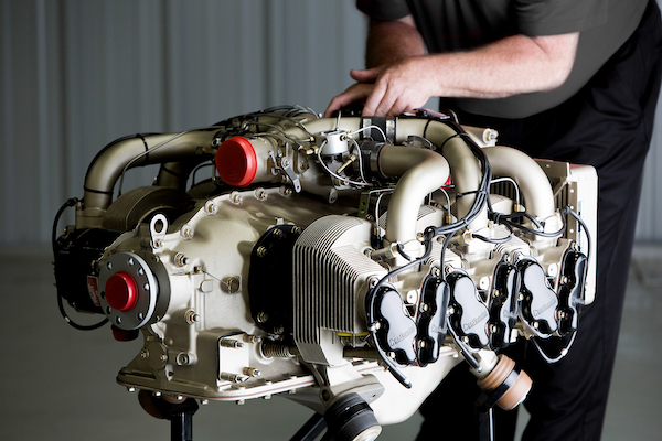 Continental Aerospace Technologies™ Increases Warranty Coverage for Certified AvGas Engines A new uninstalled Continental Aerospace Technologies certified AvGas aircraft engine is held up by a technical in a workshop.