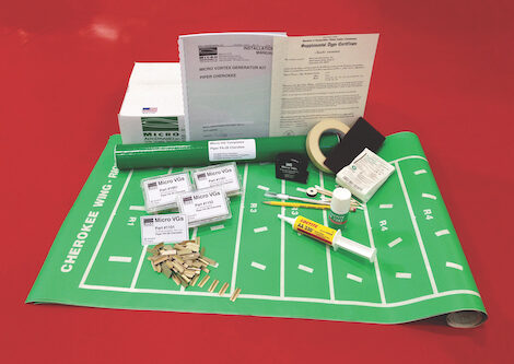 A Micro Vortex Generator installation kit laid out with templates, instructions, small fins, adhesive tubes, and tools.