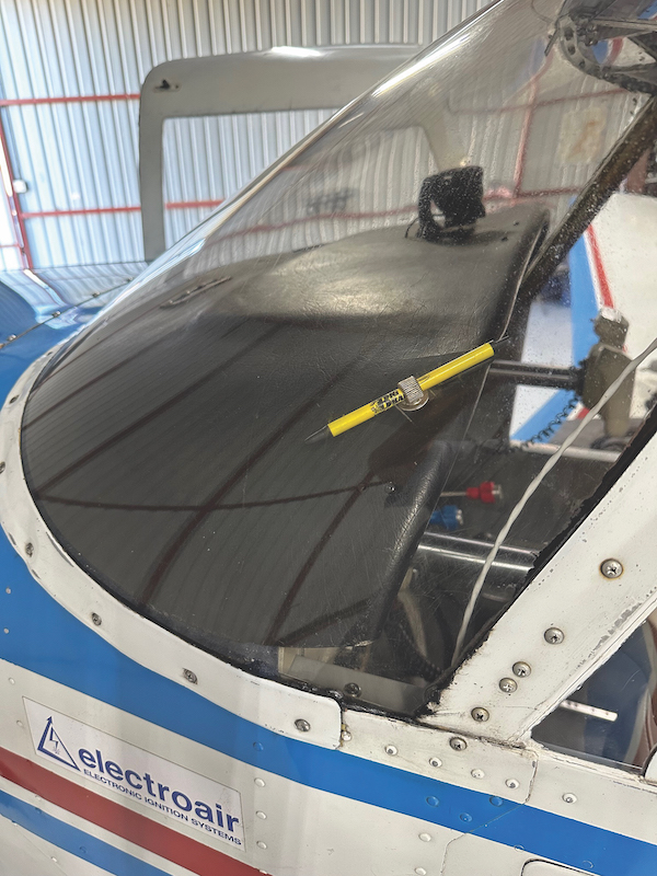 Front windshield of a blue and white aircraft showing the installed black textured Ashby glareshield sitting smoothly across the top of the instrument panel.